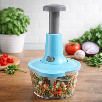 Blue handheld food chopper with chopped vegetables on a wooden table